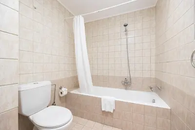 a bathroom with a toilet and a bath tub at Villa Mediterranean Blue in Yennadhion