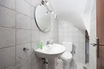 a bathroom with a sink and a toilet and a mirror at Villa Mediterranean Blue in Yennadhion