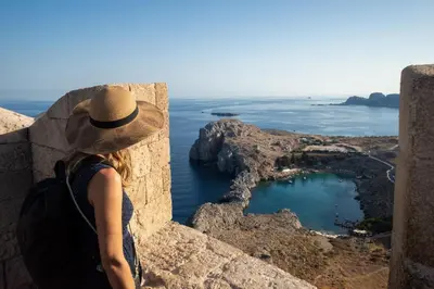 a woman in a hat looking out over the ocean at Villa Mediterranean Blue in Yennadhion