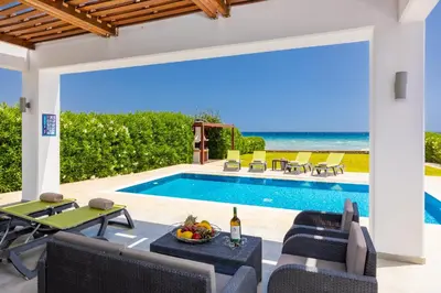 a villa with a swimming pool and a patio at Villa Metis in Lachania