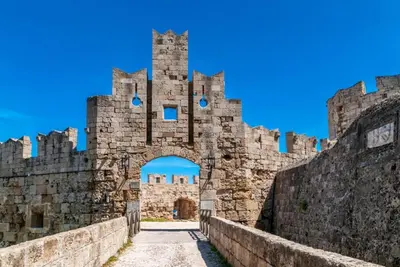 an entrance to a castle with a stone wall at Villa Metis in Lachania