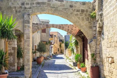 an archway over an alley in an old town at Villa Metis in Lachania