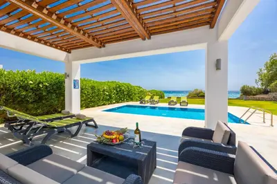 a patio with a view of a swimming pool at Villa Dionysos in Lachania