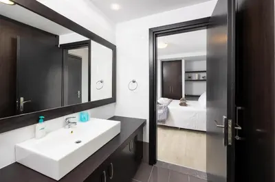 a bathroom with a sink and a mirror and a bed at Villa Dionysos in Lachania