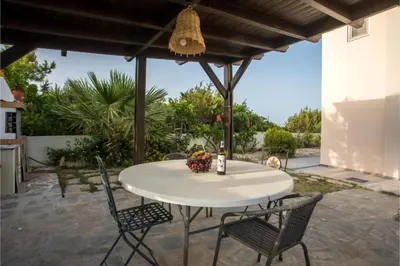 a white table and chairs on a patio at Villa Verona Pool in Lachania