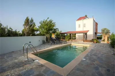 a swimming pool in front of a house at Villa Verona Pool in Lachania