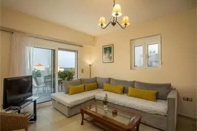 a living room with a couch and a tv at Villa Verona Pool in Lachania