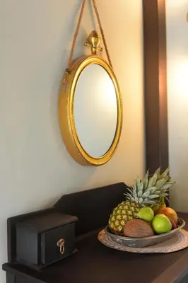 a plate of fruit on a table with a mirror at Elaia-Fos in Rhodes Town