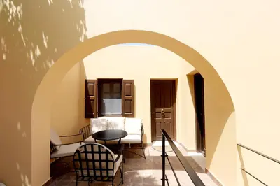 an archway in a room with a table and chairs at Elaia-Fos in Rhodes Town