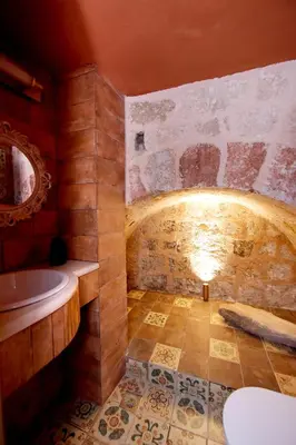 a bathroom with a tub and a sink at Elaia-Fos in Rhodes Town