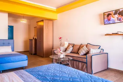 a living room with a couch and a table at Haven Beach in Faliraki