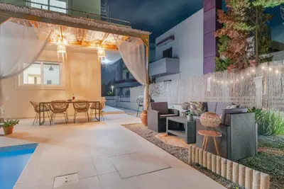 an outdoor patio with a dining area and a table and chairs at Casa Elia Filerimos in Pastida