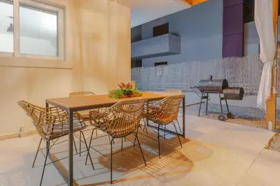 a table and chairs in a kitchen with a grill at Casa Elia Filerimos in Pastida
