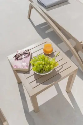 a table with a bowl of grapes and an orange on it at Casa Elia Filerimos in Pastida