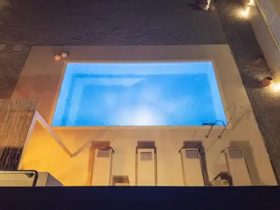 an overhead view of a large swimming pool with chairs at Casa Elia Filerimos in Pastida