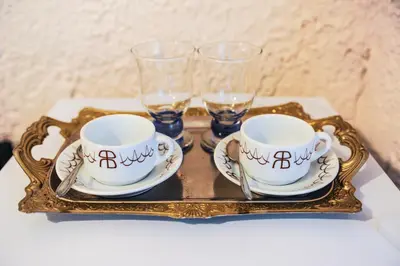 a tray with two cups and glasses on a table at Valentino Hotel in Kremasti