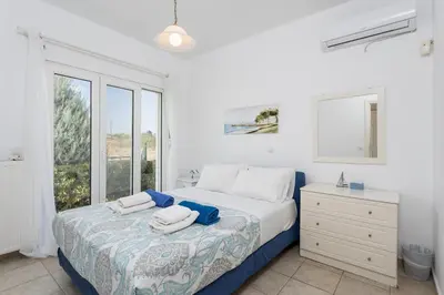 a bedroom with a bed with towels on it at Hermione Villa in Gennadi