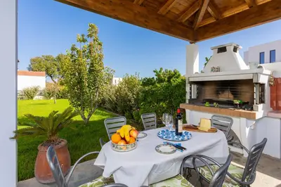 a table with a bowl of fruit on a patio at Hermione Villa in Gennadi