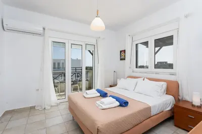 a bedroom with a large bed with towels on it at Hermione Villa in Gennadi