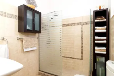 a bathroom with a glass shower and a sink at Villa Alnika Acacia by Villa Plus in Lachania