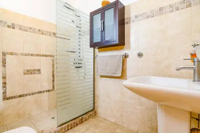 a bathroom with a sink and a shower at Villa Alnika Azalea by Villa Plus in Lachania