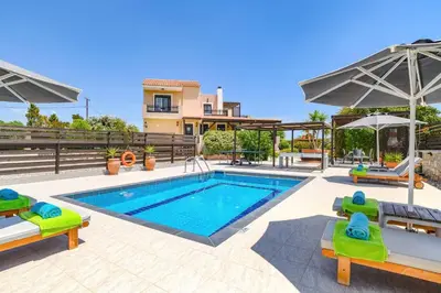 a villa with a swimming pool and a house at Villa Alnika Azalea by Villa Plus in Lachania