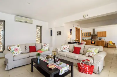 a living room with two couches and a table at Villa Anastasia Rodos by Villa Plus in Líndos