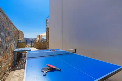 a ping pong table with a ping paddle on it at Villa Anastasia Rodos by Villa Plus in Líndos