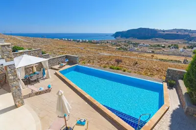 a villa with a swimming pool and a view of the ocean at Villa Anastasia Rodos by Villa Plus in Líndos