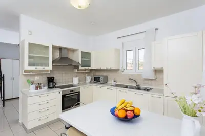 a kitchen with a bowl of fruit on a table at Amphitrite Villa in Gennadi