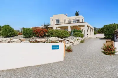 a white house with a sign in front of it at Villa Sophie Gennadi in Gennadi