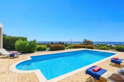 a swimming pool with blue water in a yard at Villa Sophie Gennadi in Gennadi