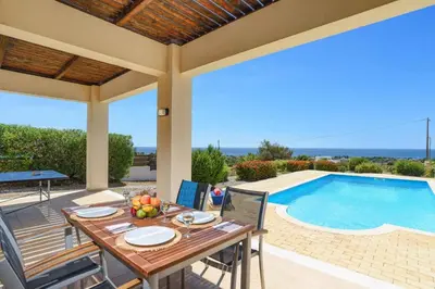 a patio with a table and a swimming pool at Villa Sophie Gennadi in Gennadi
