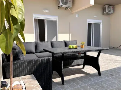 a living room with a couch and a table at Seaside Deluxe Apartment in Ialyssos