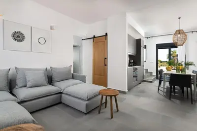 a living room with a couch and a table at Seafish Villa, 2 Luxury Villas at Lachania Beach in Lachania