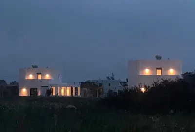 two white buildings with their lights on at night at Seafish Villa, 2 Luxury Villas at Lachania Beach in Lachania