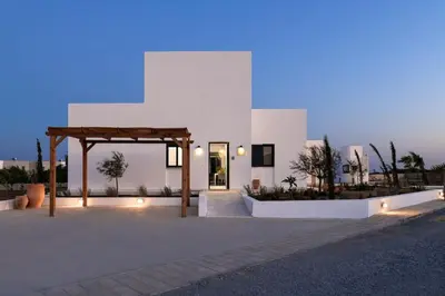 a white building with a pavilion in front of it at Seafish Villa, 2 Luxury Villas at Lachania Beach in Lachania