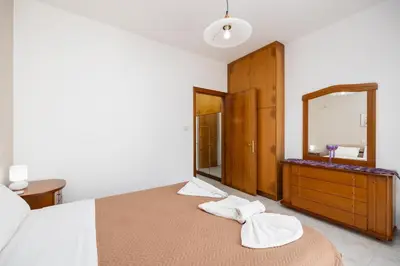 a bedroom with a bed and a large mirror at Villa Sunset Paradise in Kalavárda