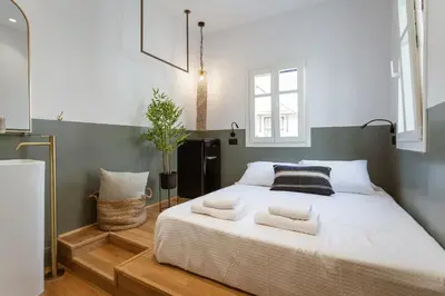 a bedroom with a large bed with pillows on it at Zerania Selana Studio in Rhodes Town