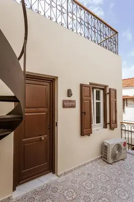 a house with a door and a microwave on the floor at Zerania Selana Studio in Rhodes Town