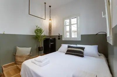 a bedroom with a large white bed with towels on it at Zerania Selana Studio in Rhodes Town