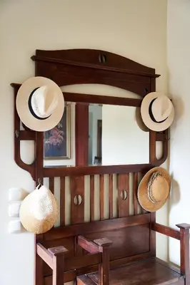 a mirror with hats hanging on a wall at Villa Eremia in Pastida
