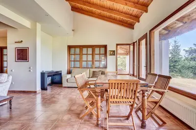a dining room with a table and chairs at Villa Eremia in Pastida