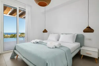 a bedroom with a bed with towels on it at Sunset Hill Villa Rhodes in Gennadi