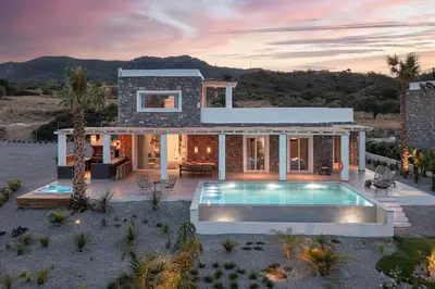 a house with a swimming pool in front of it at Sunset Hill Villa Rhodes in Gennadi
