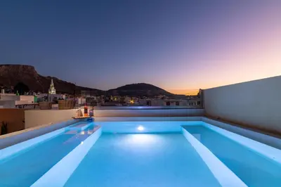a swimming pool on the roof of a building at Antheia Traditional House in Archangelos