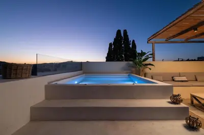 a swimming pool on the side of a house at Antheia Traditional House in Archangelos