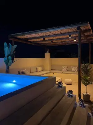 a swimming pool in a backyard at night at Antheia Traditional House in Archangelos