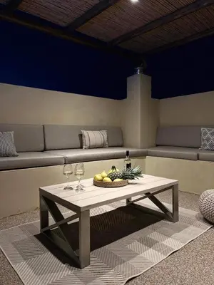 a table with two wine glasses and a bowl of fruit at Antheia Traditional House in Archangelos