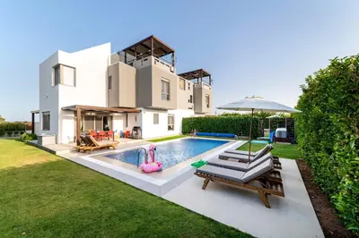 a house with a swimming pool in the backyard at Filoxenia Villas in Gennadi